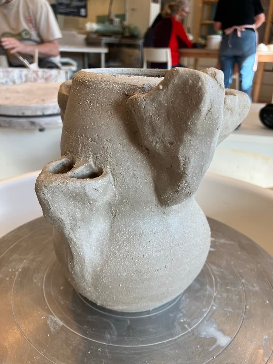 Raw clay on wheel — side view